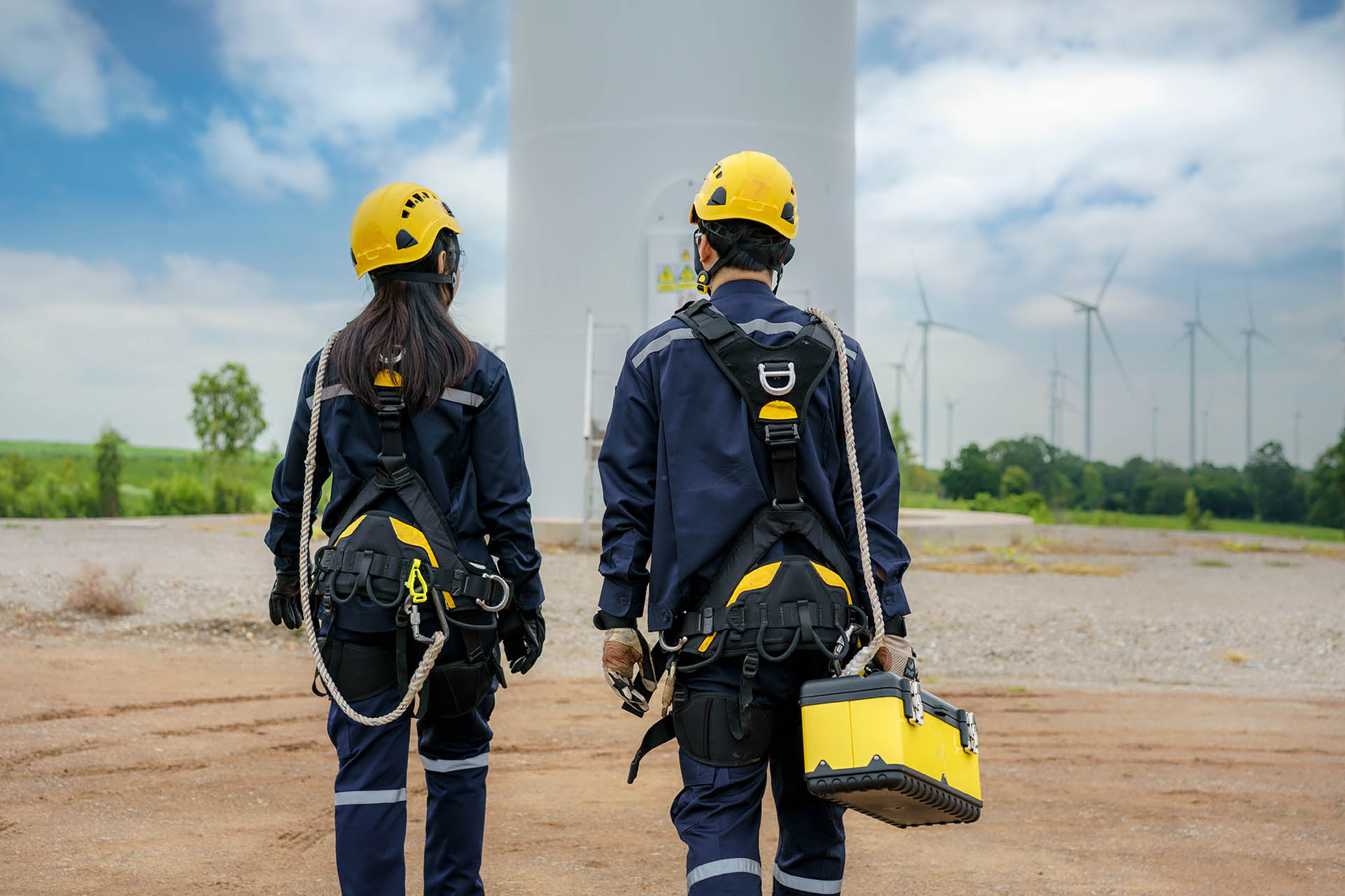 man and woman Inspection engineers preparing and progress safety check of a wind turbine
